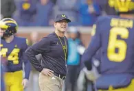  ?? CARLOS OSORIO/ASSOCIATED PRESS FILE PHOTO ?? Coach Jim Harbaugh is 28-11 since taking over Michigan, but the Wolverines have gone 1-5 against Ohio State and Michigan State.