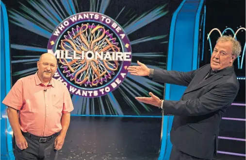  ??  ?? MILLIONAIR­E: Host Jeremy Clarkson with contestant Donald Fear after he become the sixth champion in the ITV show’s 22-year history