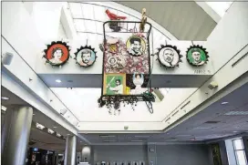  ??  ?? A work by Joni Mabe celebratin­g Southern icons and featuring portraits of William Faulkner and Ty Cobb, among others, is one of the many artworks that define Hartsfield-Jackson Internatio­nal Airport’s art program.