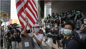  ?? AP file ?? RISKING THEIR FREEDOM: Hong Kong residents protest outside the U.S. Consulate on the Fourth of July.