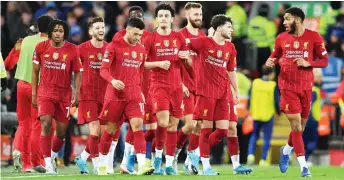  ?? — AFP Photo ?? Liverpool’s midfielder Curtis Jones (centre) celebrates with teammates after scoring the opening goal of the English FA Cup third round match against Everton at Anfield in Liverpool, north west England.