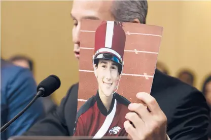  ?? JOSE LUIS MAGANA / AP ?? Safe Schools for Alex founder and CEO Max Schachter holds a picture of his son Alex as he testifies before a subcommitt­ee hearing on school security in Washington, D.C., in 2019. Alex was one of 17 people killed in the 2018 shooting at Marjory Stoneman Douglas High School in Florida.