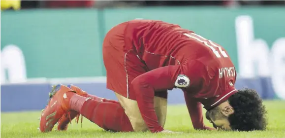  ??  ?? Liverpool midfielder Mohamed Salah celebrates after scoring the opening goal from the penalty spot during the English Premier League football match against Brighton and Hove Albion at American Express Community Stadium in Brighton, southern England, yesterday.