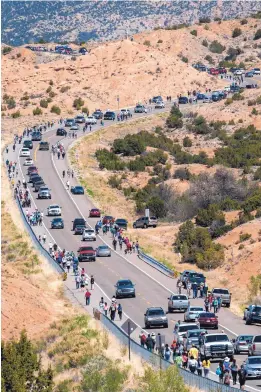  ?? EDDIE MOORE/JOURNAL ?? Thousands walk along Juan Medina Road on their way to El Santuario de Chimayó on a warm, sunny Good Friday. The 200-year-old shrine attracts tens of thousands each year during Holy Week.