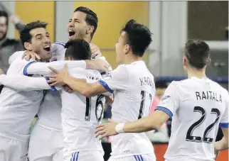  ?? TED S. WARREN/THE ASSOCIATED PRESS ?? Impact forward Jeisson Vargas, centre, is mobbed by teammates after scoring Saturday against the Sounders in Seattle. It was the lone goal of the match as Montreal won 1-0.