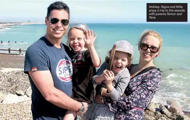  ??  ?? Holiday: Signe and Mille enjoy a trip to the seaside with parents Simon and Yane