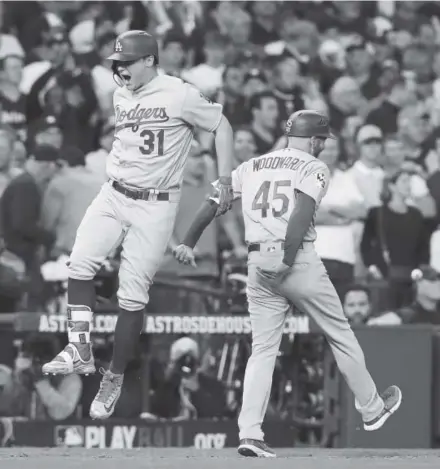  ?? Tom Pennington, Getty Images ?? Dodgers’ Joc Pederson, left, celebrates after hitting a three-run home run during the ninth inning.