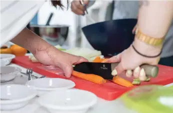  ??  ?? CELEBRITY CHEFS and a burn victim collaborat­e in the cooking of a delicious meal.A BURN victim has her caricature drawn at the groundbrea­king ceremony. The most common children’s injury in Israel’s winter months is burns.