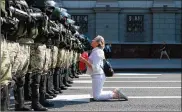  ?? ASSOCIATED PRESS ?? Awomanknee­ls in frontof a riot police lineas theyblock Belarusian opposition supporters rally in the center of Minsk, Belarus, Sunday. Protests began after the Aug. 9 presidenti­al election.