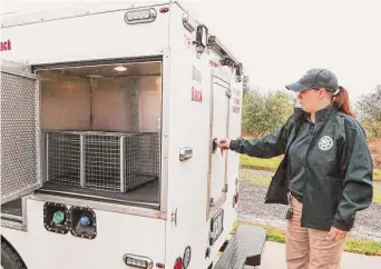  ?? Jason Fochtman/Staff photograph­er ?? Montgomery County Animal Control Officer Tracy Allen shows the inside of one of the animal shelter’s air conditione­d vehicles used to transport animals.