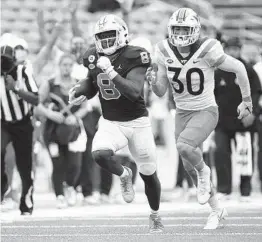  ?? ROBERT WILLETT AP ?? North Carolina’s Michael Carter, who rushed for 214 yards and two TDS, breaks away from Virginia Tech’s Tyler Matheny for a 62-yard touchdown Saturday.