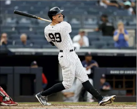  ?? ADAM HUNGER - THE ASSOCIATED PRESS ?? New York Yankees’ Aaron Judge hits a three-run home run against the Minnesota Twins during the eighth inning of a baseball game on Monday, Sept. 13, 2021, in New York.