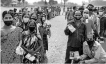  ?? PHOTO: PTI ?? Voters wait in queues to cast votes at a polling station during the 7th phase of West Bengal Assembly elections in South Dinajpur