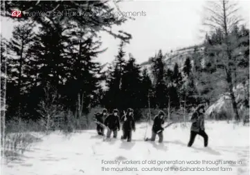  ?? courtesy of the Saihanba forest farm ?? Forestry workers of old generation wade through snow in the mountains.