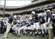  ?? CHRIS KNIGHT — THE ASSOCIATED PRESS ?? In this Saturday, Sept. 15, 2018, file photo, Penn State head coach James Franklin, left, holds the team back before taking the field against Kent State in an NCAA college football game in State College.