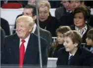  ?? THE ASSOCIATED PRESS ?? President Donald Trump smiles with his son Barron as they view the 58th Presidenti­al Inaugurati­on parade for President Donald Trump in Washington on Friday.