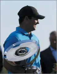  ?? MARK LENNIHAN — THE ASSOCIATED PRESS ?? Patrick Reed holds the FedEx Cup Trophy after winning the Northern Trust golf tournament at Liberty National Golf Course, Sunday.