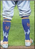  ??  ?? Mets center fielder Juan Lagares’ socks are shown before the start of a game April 15 against the Marlins in Miami.