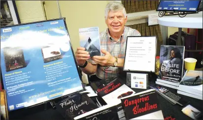  ?? Ernest A. Brown photos ?? Pictured clockwise from top photo, Julian Ayotte, a local bestsellin­g author, takes part in the expo at the library Saturday; Bob Sherman’s book “The Train Station,’ based on train the depot in Woonsocket was a popular draw with customers; David Aiello, of Providence, shows his book to customers based on the famous Bonded Vault robbery called “Bonded Vault.”