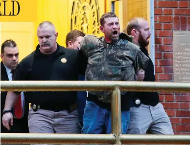  ?? JERRY LARSON / WACO TRIBUNE- HERALD VIA AP ?? Gordon Coble is led out of the of the Texas State Penitentia­ry in Huntsville, Texas, Thursday during his father’s execution. Coble and 21-year-old Dalton Coble were arrested on charges of resisting arrest and disorderly conduct.