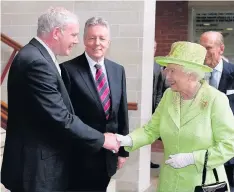  ??  ?? > Northern Ireland’s former Deputy First Minister Martin McGuinness shakes hands with the Queen in June 2012 in Belfast