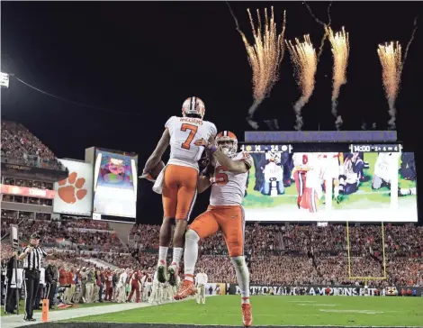  ?? ASSOCIATED PRESS ?? Mike Williams (7) of Clemson celebrates his touchdown reception during the second half with Jordan Legget during the national title game.