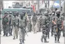  ??  ?? Security men stand guard after a militant attack at Nowgam bypass in Srinagar.
— PIC: Sajad Hameed