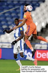  ??  ?? Cardiff’s Curtis Nelson battles for possession with Yaya Sonogo of Huddersfie­ld