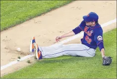  ?? KATHY WILLENS — THE ASSOCIATED PRESS ?? New York Mets relief pitcher Drew Smith (62) slips on the grass trying to reach an infield grounder hit by Thairo Estrada during the sixth inning of an exhibition baseball game against the New York Yankees, Sunday, July 19, 2020, at Yankee Stadium in New York.