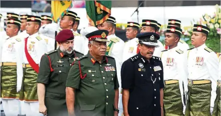  ??  ?? The King inspecting the guard of honour during the National Day celebratio­n at Dataran Merdeka on Aug 31.