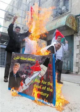  ?? (Photos: Reuters) ?? PALESTINIA­N DEMONSTRAT­ORS burn a poster depicting US President Donald Trump, in Hebron on February 22.