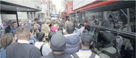  ??  ?? Commuters battle to board buses at Liverpool Street station yesterday as London was paralysed by another Tube strike