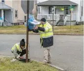  ?? MICHAEL SWENSEN/GETTY ?? EPA contractor­s maintain air monitoring systems Friday in East Palestine, Ohio. A Norfolk Southern Railways train with toxic chemicals derailed Feb. 3.