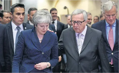  ?? AFP ?? British Prime Minister Theresa May, left, is welcomed by European Commission President Jean-Claude Juncker, centre, and Brexit Chief negotiator Michel Barnier, right, at the European Commission in Brussels on Saturday.