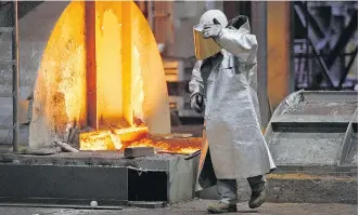  ?? MARTIN MEISSNER/AP ?? A worker at ThyssenKru­pp’s steel factory in Duisburg, Germany. The proposed merger between ThyssenKru­pp and India’s Tata Steel would create a company with annual revenue of about 15 billion euros.