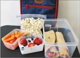 ??  ?? A healthful packed school lunch should include calcium‑rich item, a whole grain and a vegetable or a fruit.