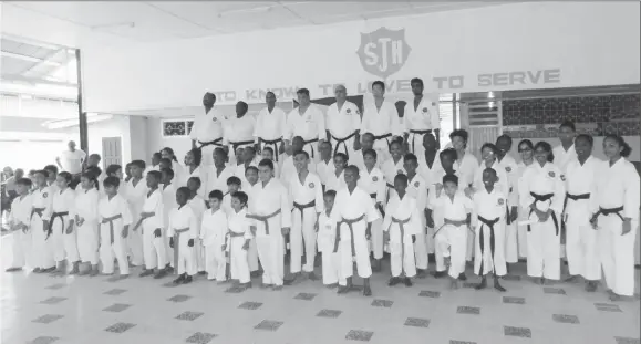  ??  ?? The karatekas pose for a group photo following their grading exams last Saturday.