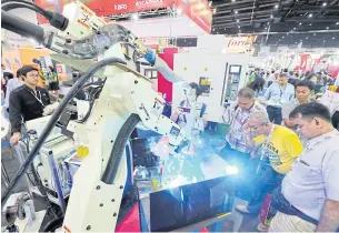  ??  ?? Machinery manufactur­ers display their advance machines and technologi­es to attract factory owners at an Intermach trade fair.