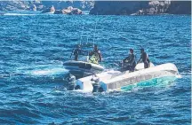  ?? ?? Three men on the state's East Coast are rescued by police after their boat capsized.
