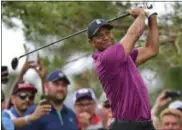  ?? DAVID DERMER — ASSOCIATED PRESS ?? Tiger Woods follows through on his swing on the 10th hole during the Memorial pro-am May 30 in Dublin.