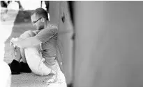  ?? ALEJANDRO TAMAYO / SAN DIEGO UNION-TRIBUNE ?? Hristakopo­ulos sits at the gate in front of Pulse on June 20