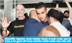  ??  ?? MELBOURNE: Supporters receive footballer Hakeem Al-Araibi (center) upon his arrival at the airport with former Australian football captain Craig Foster (left) yesterday. —AFP