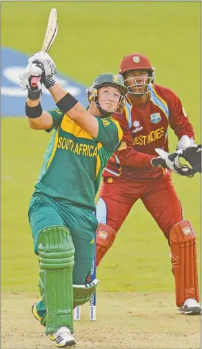  ?? PHOTOGRAPH: REUTERS ?? LASHING OUT: South Africa opener Colin Ingram slams a six as West Indies wicketkeep­er Johnson Charles looks on in their clash yesterday