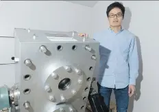  ?? MICHAEL BELL ?? Xiang Zhou stands beside a 3-D model used to study fluid dynamics in Qingwang Yuan’s lab at the University of Regina. Yuan has developed software that predicts the way oil will react with fluids injected into wells during the heavy oil recovery process.