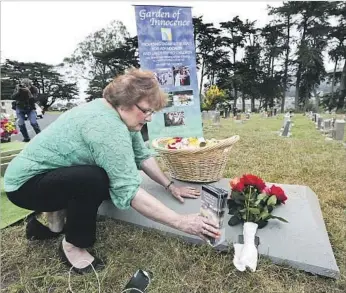  ?? Mel Melcon Los Angeles Times ?? ELISSA DAVEY prepares for a service in June at the Garden of Innocence in Colma, Calif., for the girl then known as Miranda Eve. One side of her headstone was left blank in hopes that she’d be identified.