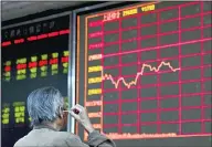  ?? (AP) ?? AAn investor digs his ear while monitoring stock prices at a brokerage in Beijing on Wednesday, Sept 25, 2019. China’s equities benchmark and blue-chip index closed down on Monday after reports the Trump administra­tion was considerin­g delisting Chinese companies from US
stock exchanges.