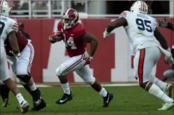  ?? VASHA HUNT — THE ASSOCIATED PRESS ?? Alabama running back Damien Harris carries the ball through a hole during the first half of the Iron Bowl against Auburn Saturday.