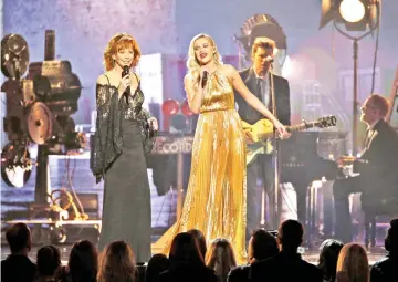  ??  ?? Ballerini and Reba McEntire (left) perform at the 51st Country Music Associatio­n Awards show in Nashville, Tennessee, recently. (Left) Ballerini arrives at the 2016 CMT Music Awards.— Reuters file photos