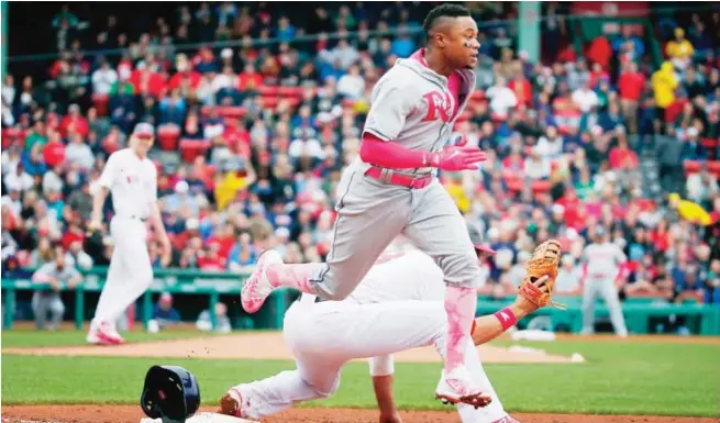  ??  ?? BOSTON: Tampa Bay Rays’ Tim Beckham, center, cannot beat the throw to Boston Red Sox’s Mitch Moreland, behind, on a ground out in the fifth inning of a baseball game. —AP