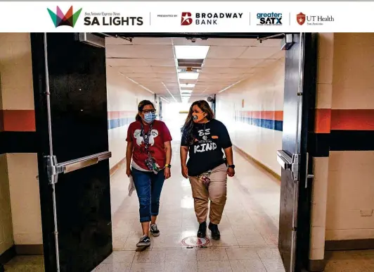  ?? Photos by Billy Calzada / Staff photograph­er ?? Life skills teacher Bianca Contreras, left, and counselor Valerie Mendoza walk down a hall on Oct. 8 at Gus Garcia University School in the Edgewood ISD.